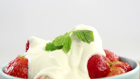 primer plano de fresas frescas con crema en el cuenco