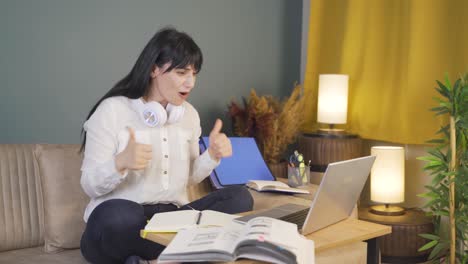 a male student who is happy that her exam results are good. at home at night.