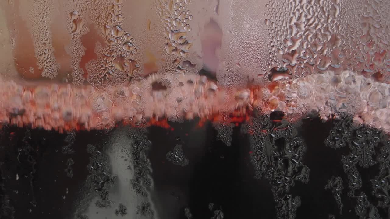 Close-up of Condensation on a Glass of Red Wine