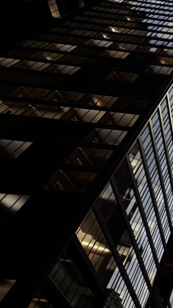 Building with glass windows in a city at dusk