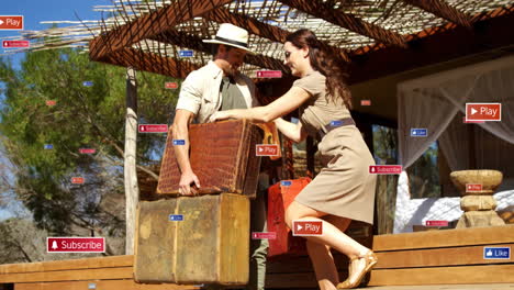 Carrying vintage suitcases, couple with animation of social media icons outdoors