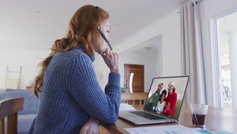 mujer caucásica en chat de video portátil durante la navidad en casa
