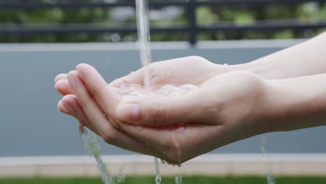 splash of clean water flows into the hands. the concept of saving water to make it last for a long time. conservation of natural resources.