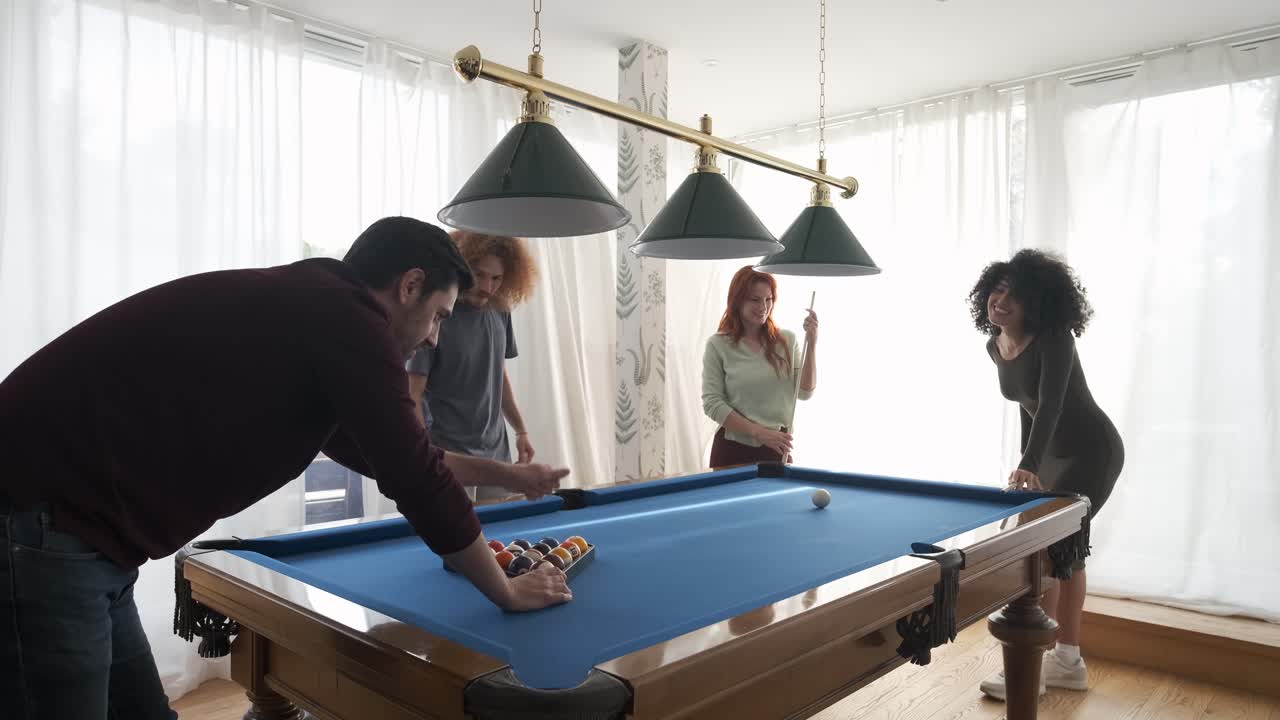 Happy black woman playing pool game with friends at home