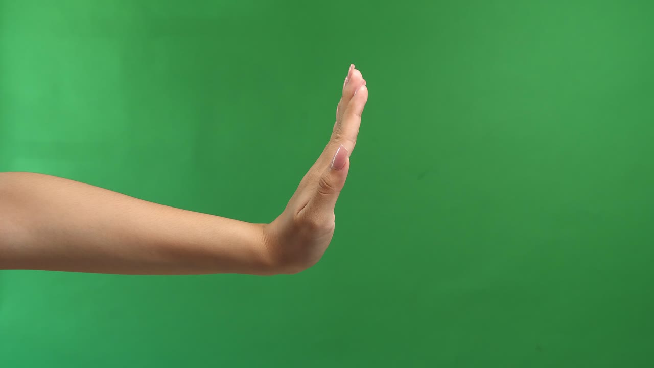Woman Hand Show Stop Sign Isolated On Green Screen Background