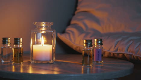 cozy nightstand with candle and essential oils