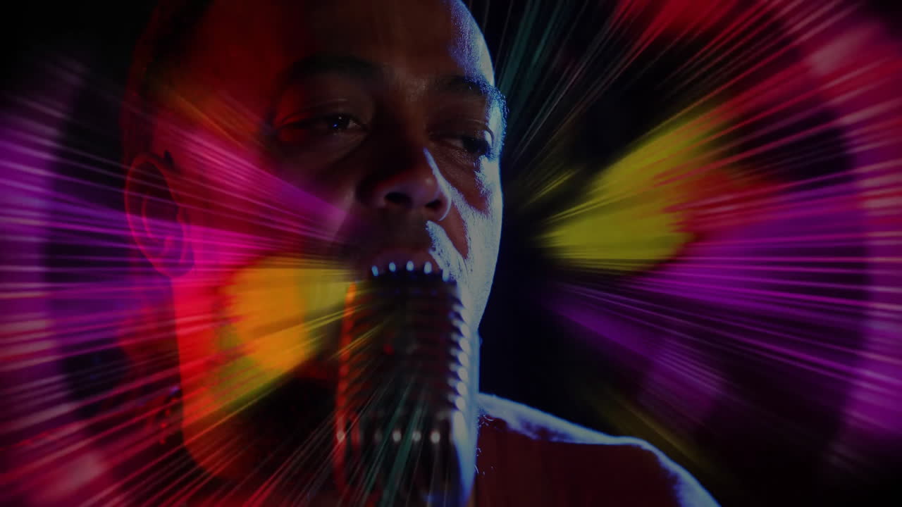 male vocalist singing into vintage mic in music studio, with animated light rays overlay