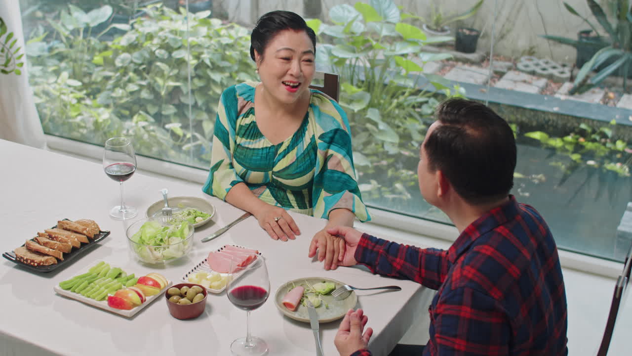 Caring Husband Touching Hand of Wife during Romantic Dinner