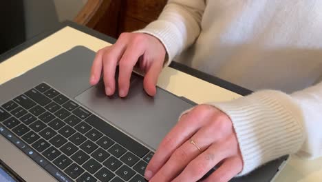 primer plano de una dama escribiendo en un teclado portátil