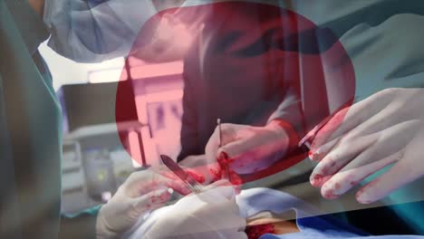 Animation-of-flag-of-japan-waving-over-surgeons-in-operating-theatre