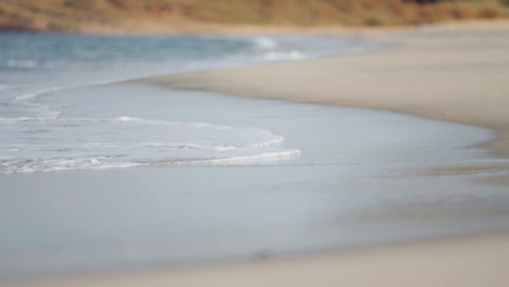 Waves-roll-slowly-and-then-recede-on-the-sandy-beach