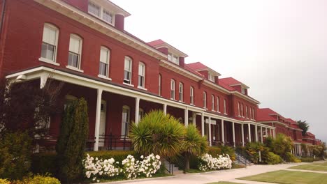 gimbal shot panning across the old navy barracks at the main parade lawn in the presidio of san francisco, california