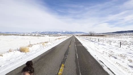 camera dolly's back revealing woman walking in the road