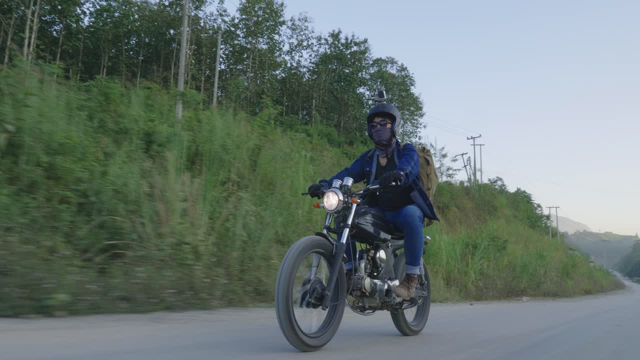 Person Riding a Motorcycle on a Country Road