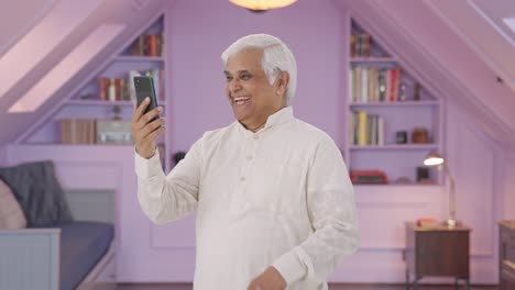 Happy-Indian-old-man-talking-on-video-call