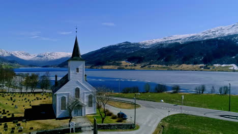 drone forward moving shot flying over jostedal church which is a parish church in luster municipality in sogn of fjordane county, norway ona sunny day