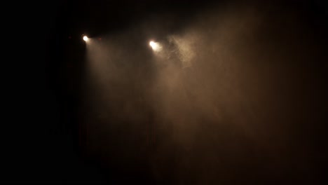 camera moves in two spots with fog on a stage