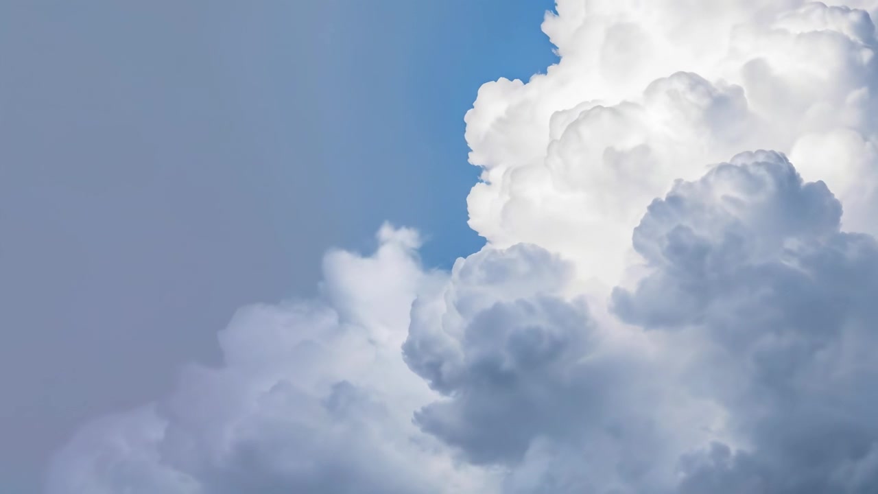 Large White Cumulus Clouds Drifting Across a Clear Blue Sky