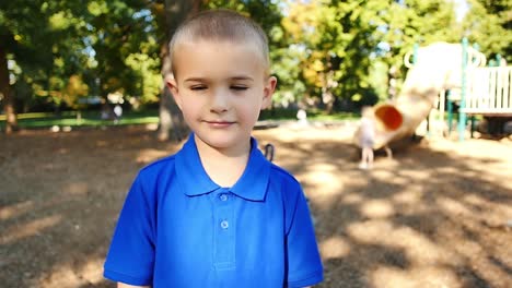 Blonde-boy-in-blue-shirt-looks-up-in-slow-motion