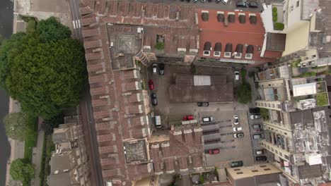 narrow streets and private apartment building yards in turin, aerial top down view