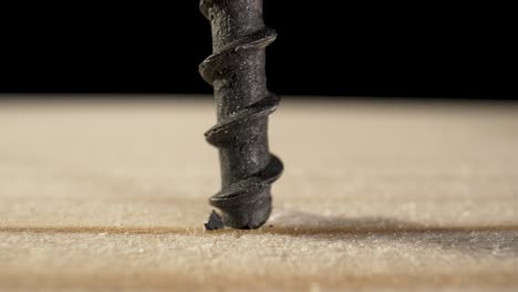 close-up of a screw being driven into wood with a screwdriver