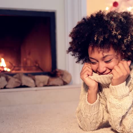 Woman-by-fireplace-and-wearing-warm-sweater