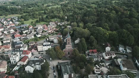 drone flying over baden-baden germany in the black forest forward while camera is panning down