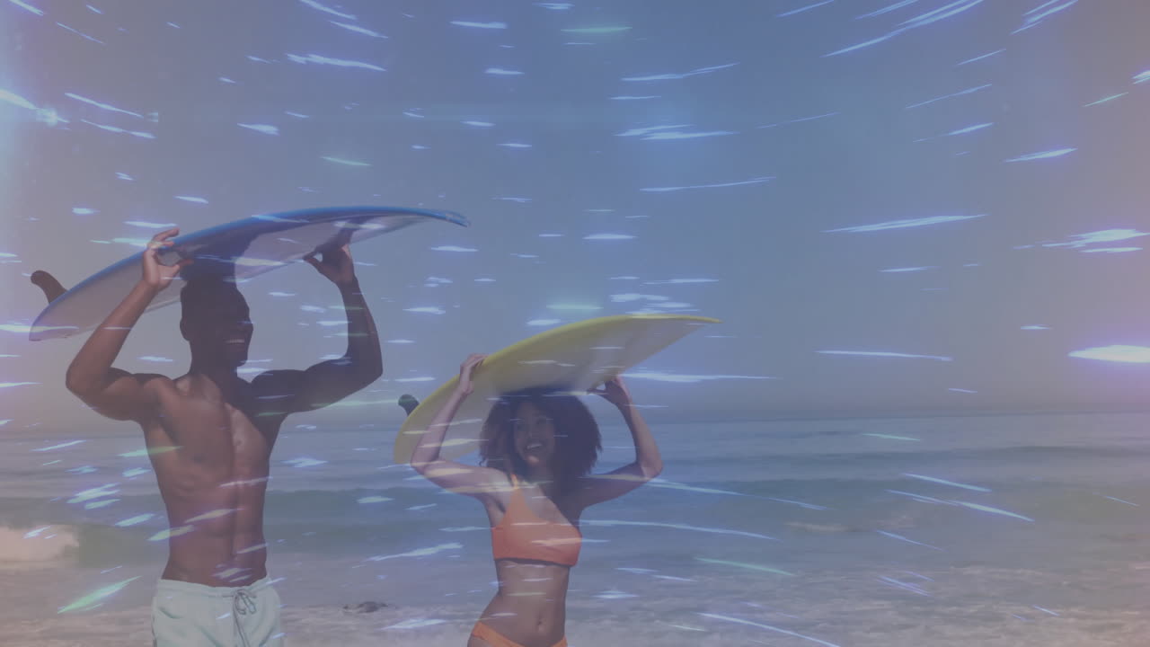 Two surfers holding surfboards above heads in beach travel marketing, showing animated wave chart
