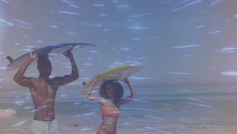 two surfers holding surfboards above heads in beach travel marketing, showing animated wave chart