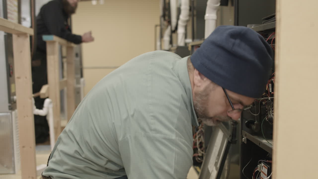 Trade school students learn to do maintenance and installation on HVAC units