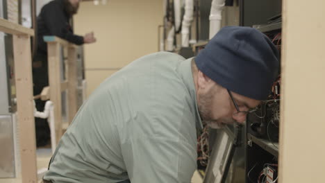 trade school students learn to do maintenance and installation on hvac units