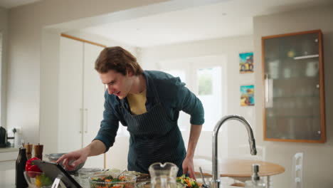 man cooking salad in kitchen