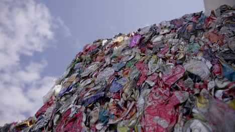 a massive hill of compressed cans and various aluminum waste