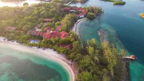 aerial top view of tropical island, sailboats and colorful reef , red roof houses in roatan island, atlantida, honduras