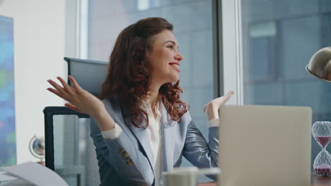 successful businesswoman rejoicing victory sitting office closeup. smiling woman