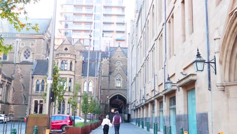 two people walking towards historic cathedral entrance