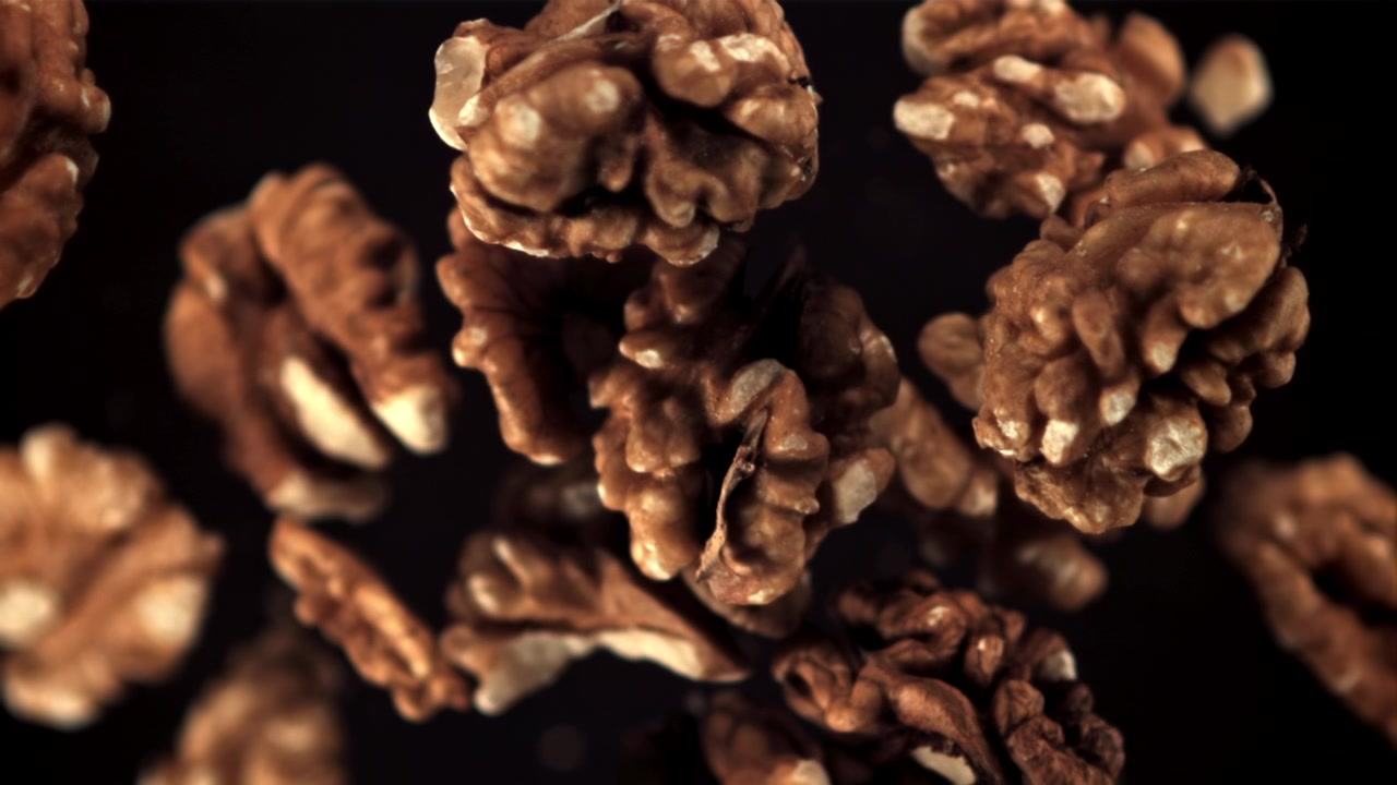 Walnut Halves Falling in Slow Motion with Focus Pull