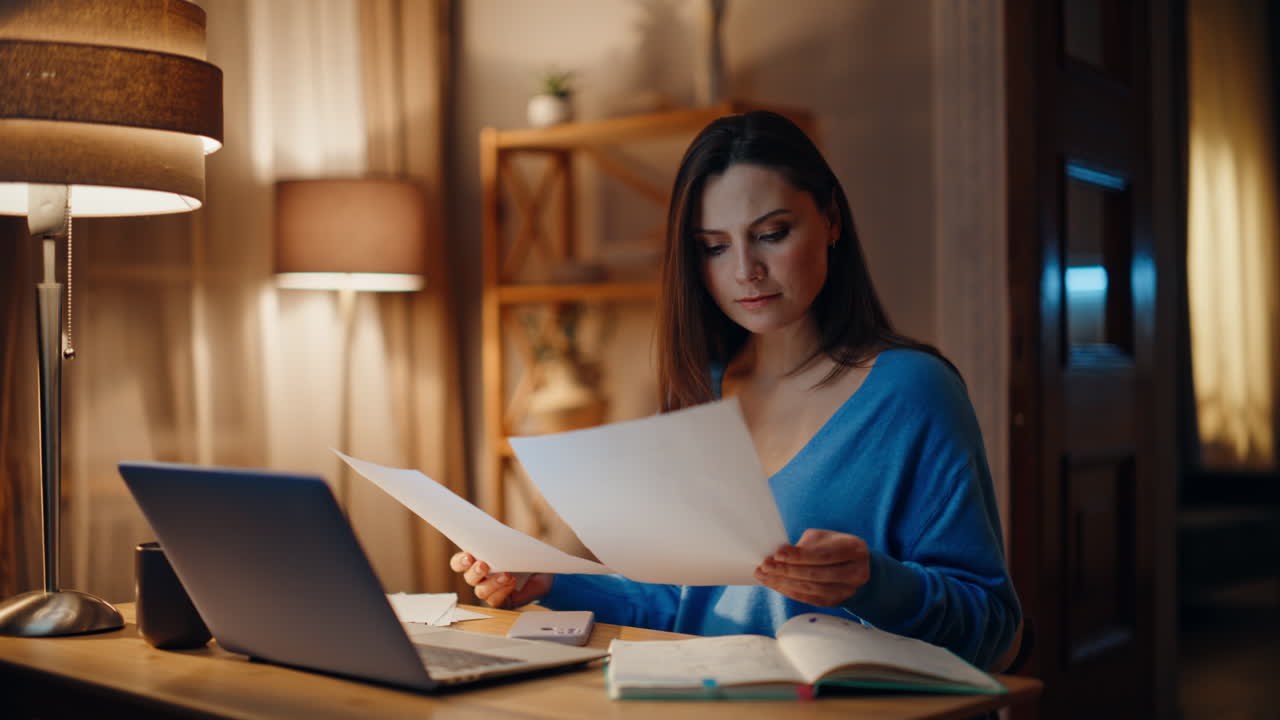 Businesswoman reading papers dark home workplace closeup. Smiling accountant