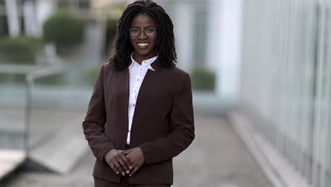 Smiling-African-American-woman-with-dreadlocks-looking-at-camera