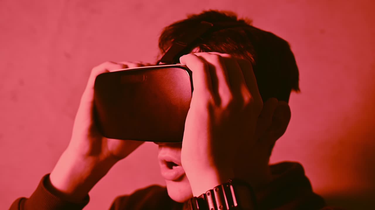 Young man amazed while wearing a virtual reality head set