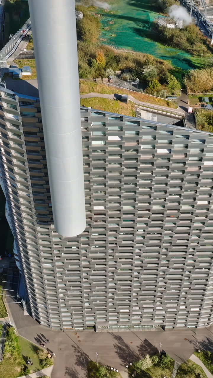 Aerial drone view of CopenHill artificial ski slope on the roof of an energy plant. Vertical