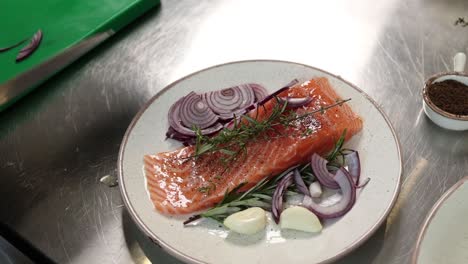 preparing salmon with herbs and onion