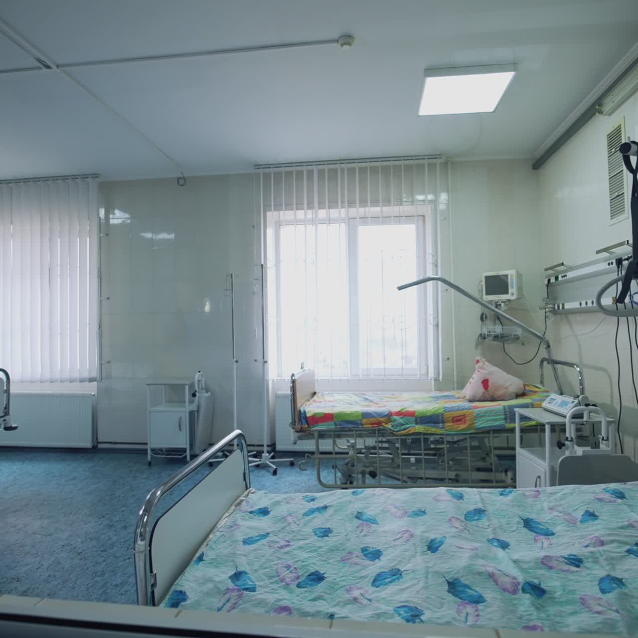 Modern ward with nobody. View from the corridor on the empty hospital room with beds and special equipment for resuscitation