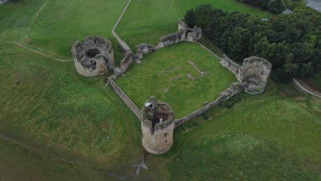 flint castle welsh medieval coastal military fortress ruin aerial birdseye tracking down view