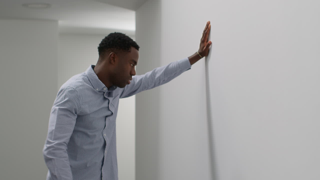 Young Businessman In Office Talking On Mobile Phone Reacting To Bad News Looking Unhappy And Depressed 3