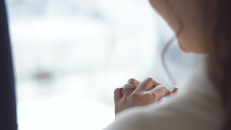 the bride looks at the engagement ring on her finger with pleasure.