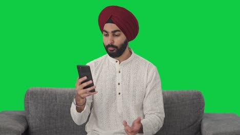 Sikh-Indian-man-talking-on-video-call-Green-screen