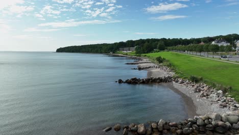 Marselisborg-beach-in-Aarhus-Denmark---Low-altitude-aerial-above-beach-with-Hotel-Helnan-Marselis-in-background