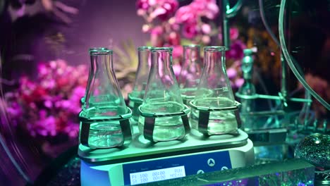 4k: laboratory flasks with transparent liquid substances, plant and flower laboratory, agriculture experiments concept inside plants nursery