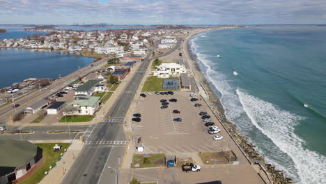 aerial fly over hull, ma, nantasket beach, with boston skyline on the horizon